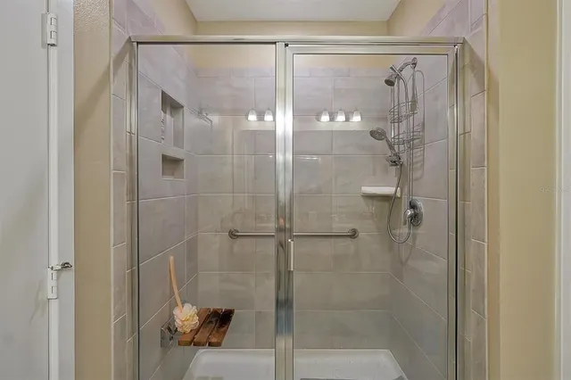 a bathroom with a glass shower door