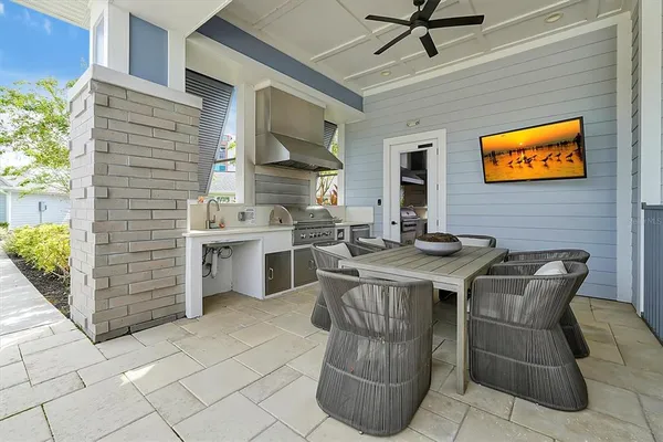 a patio with glass top table and chairs