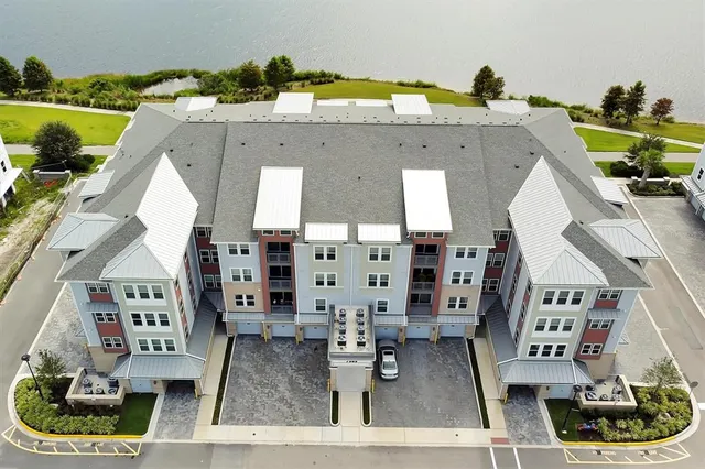a front view of a building with play ground and trees