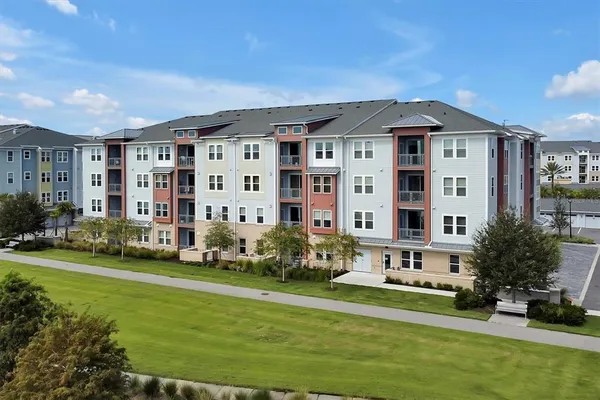 a front view of a building with a yard
