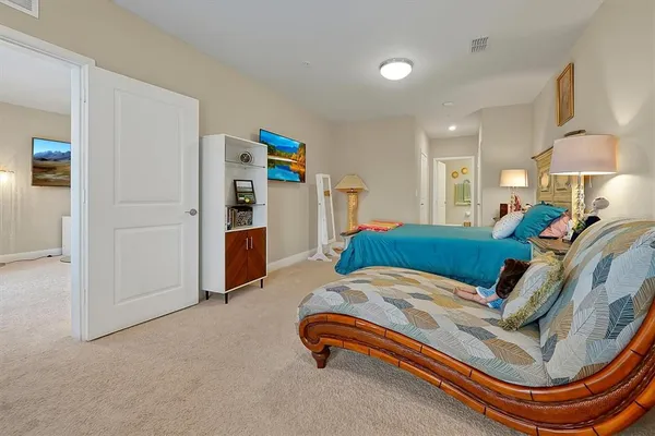 a bed room with a bed and a chair