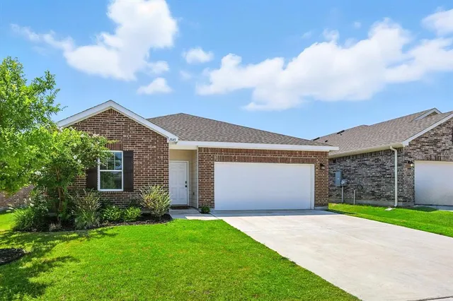 a front view of house with yard and green space