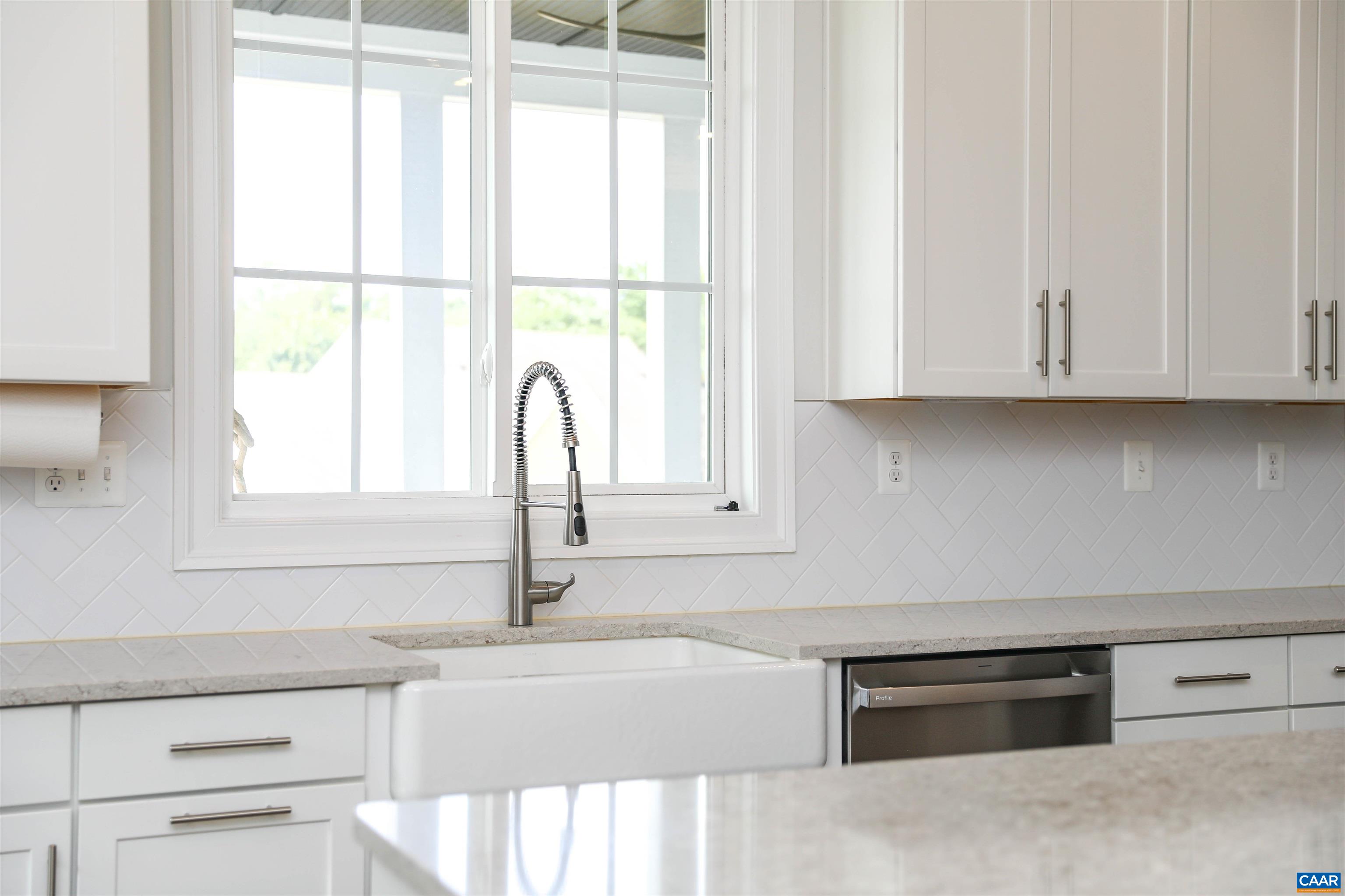 2483 Ferndown Lane Keswick, VA 22947 - Photo 14 of 54 a kitchen with granite countertop white cabinets and a window