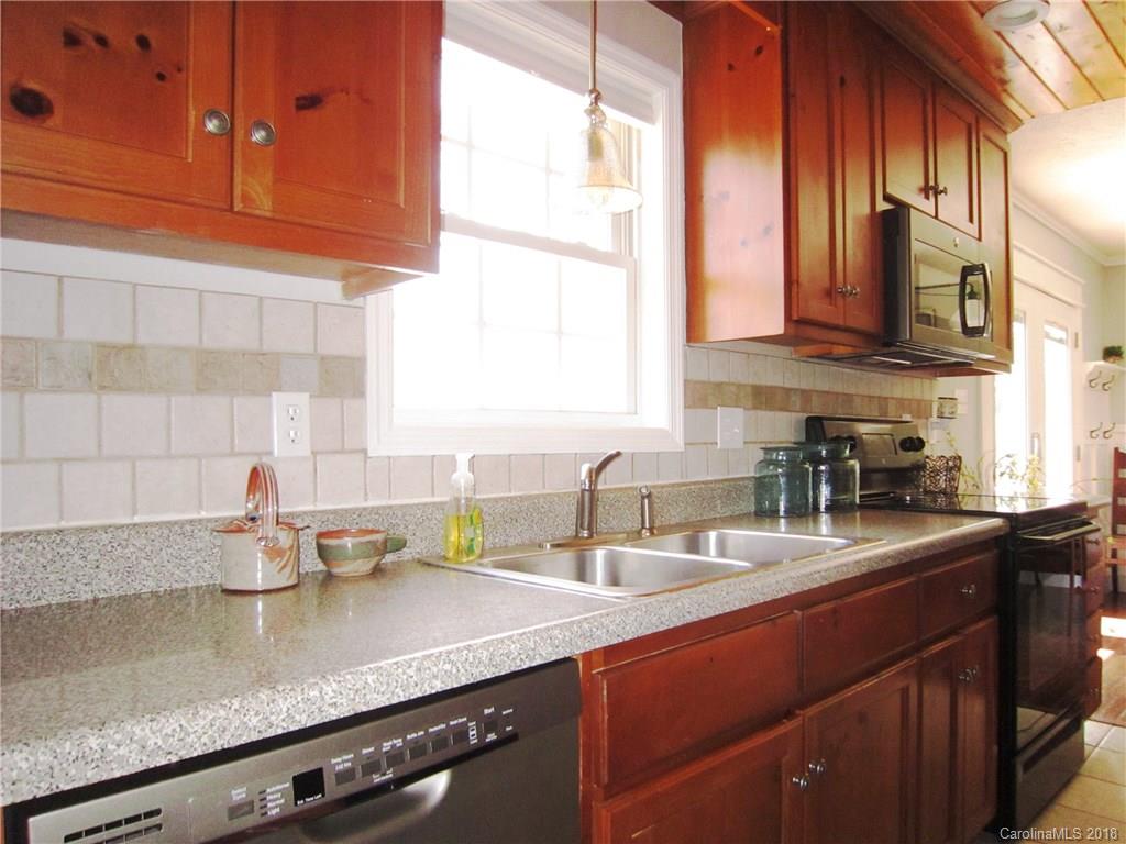 266 Murray Road Canton, NC 28716 - Photo 11 of 36 a kitchen with stainless steel appliances granite countertop a sink a stove and cabinets