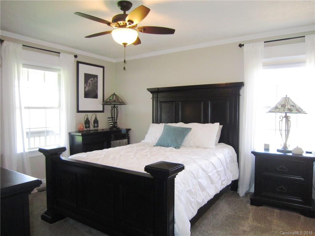 266 Murray Road Canton, NC 28716 - Photo 12 of 36 a bedroom with a bed and a chandelier