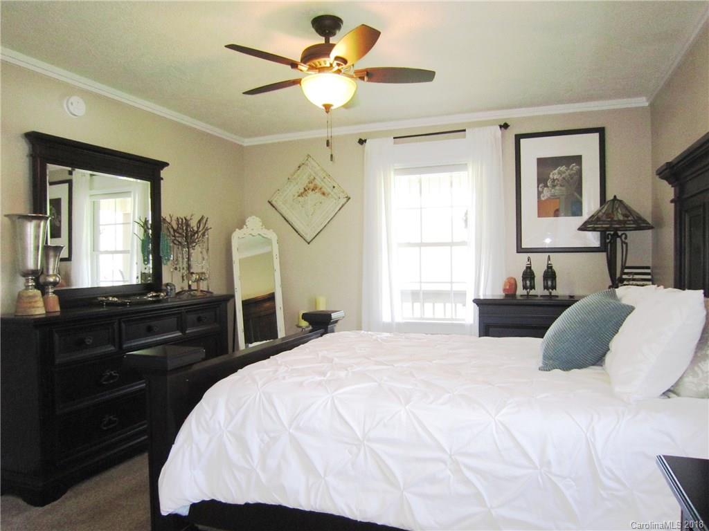 266 Murray Road Canton, NC 28716 - Photo 13 of 36 a bedroom with a bed and wooden floor
