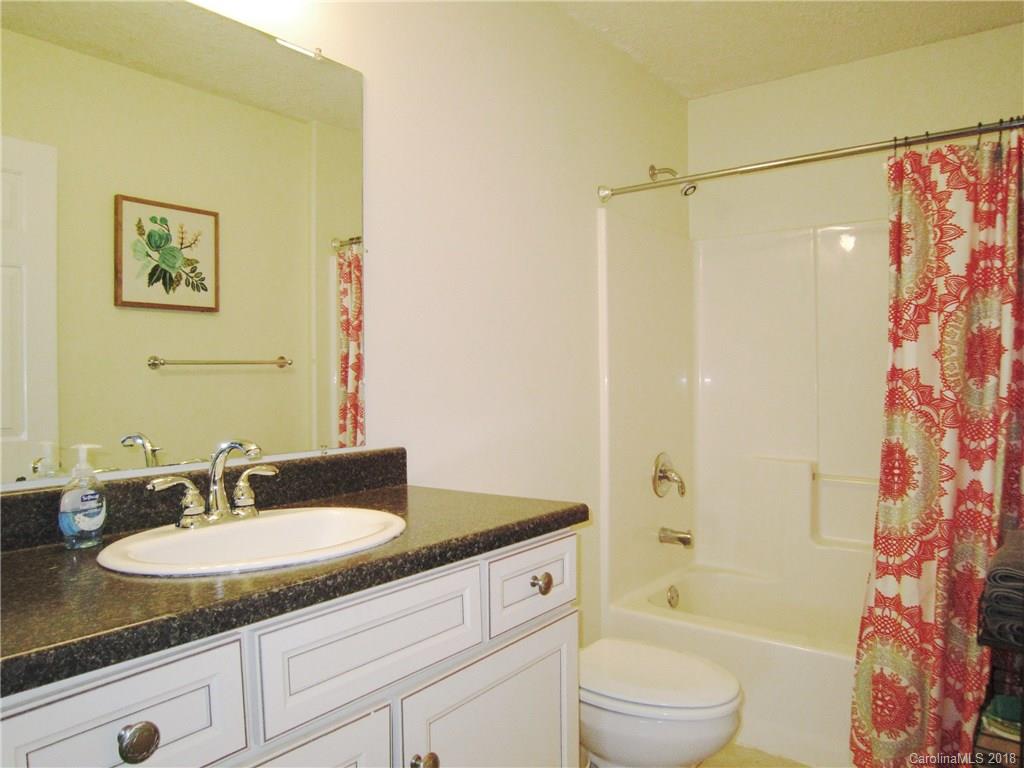 266 Murray Road Canton, NC 28716 - Photo 19 of 36 a bathroom with a granite countertop sink toilet and shower