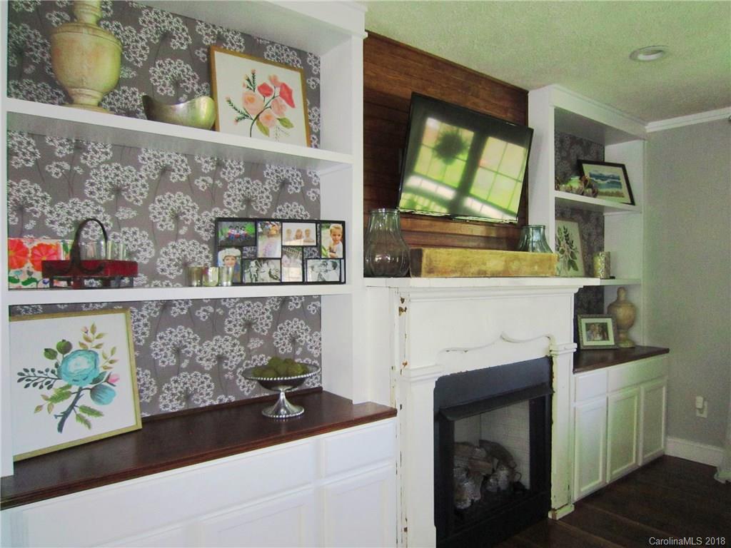 266 Murray Road Canton, NC 28716 - Photo 4 of 36 a room with painting on the wall and a fireplace