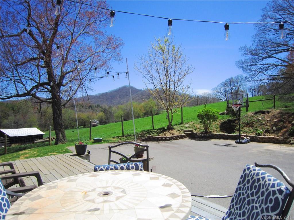266 Murray Road Canton, NC 28716 - Photo 33 of 36 a view of a patio with a table chairs and a fire pit