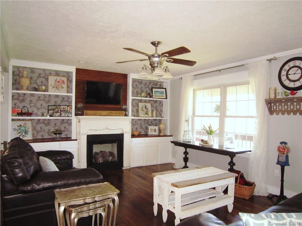 266 Murray Road Canton, NC 28716 - Photo 5 of 36 a living room with furniture a flat screen tv and a fireplace