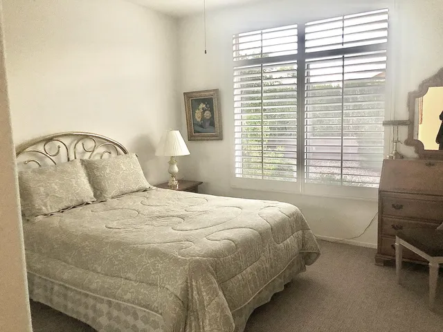 a bedroom with a bed and a tv