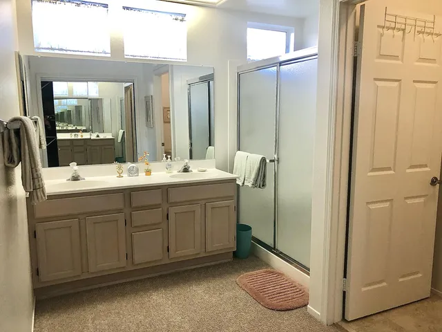 a bathroom with a double vanity sink and a mirror