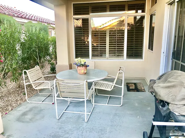 a wooden bench sitting in front of a building