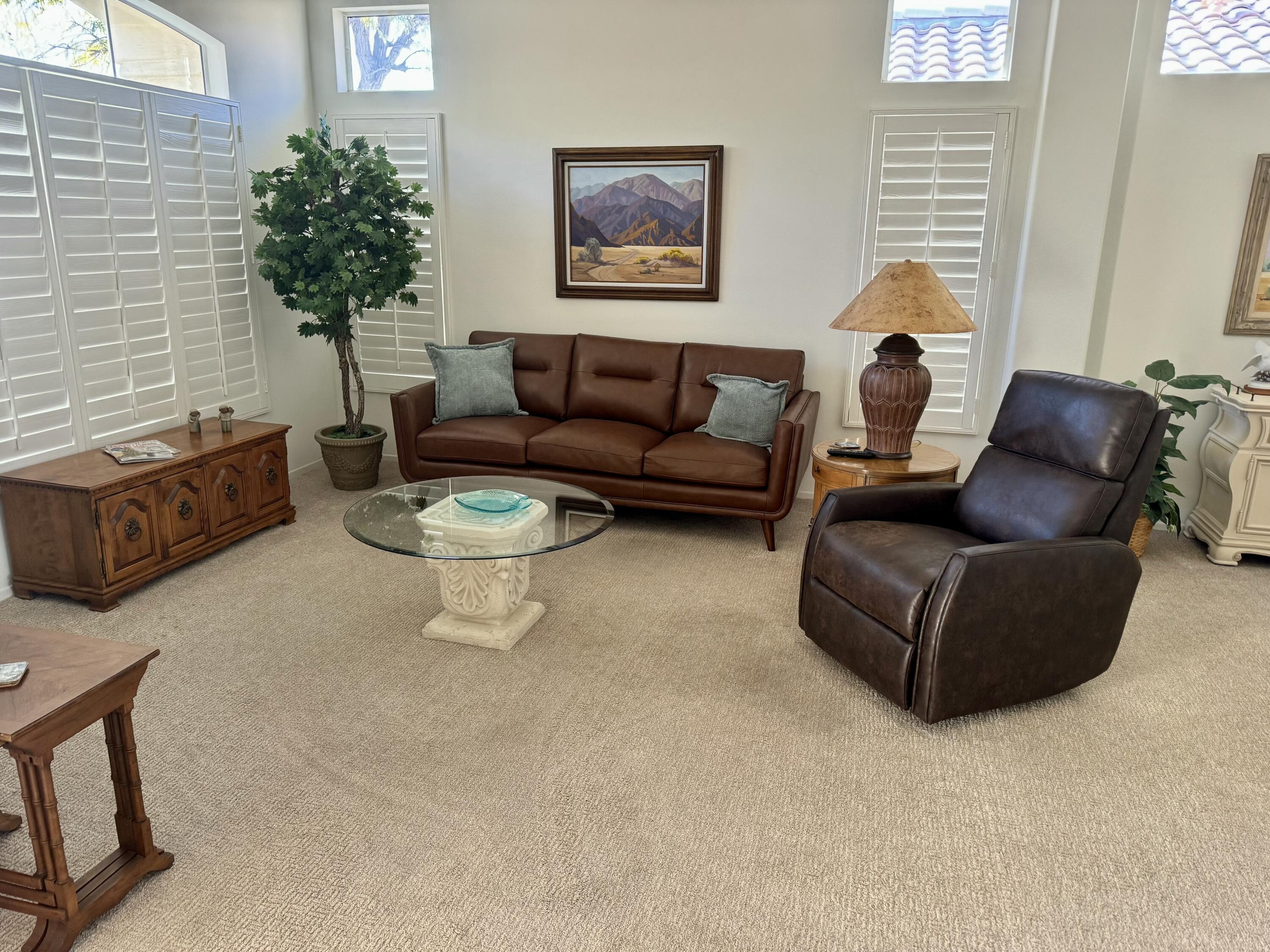 78366 Moongold Road Palm Desert, CA 92211 - Photo 17 of 17 a living room with furniture and a potted plant