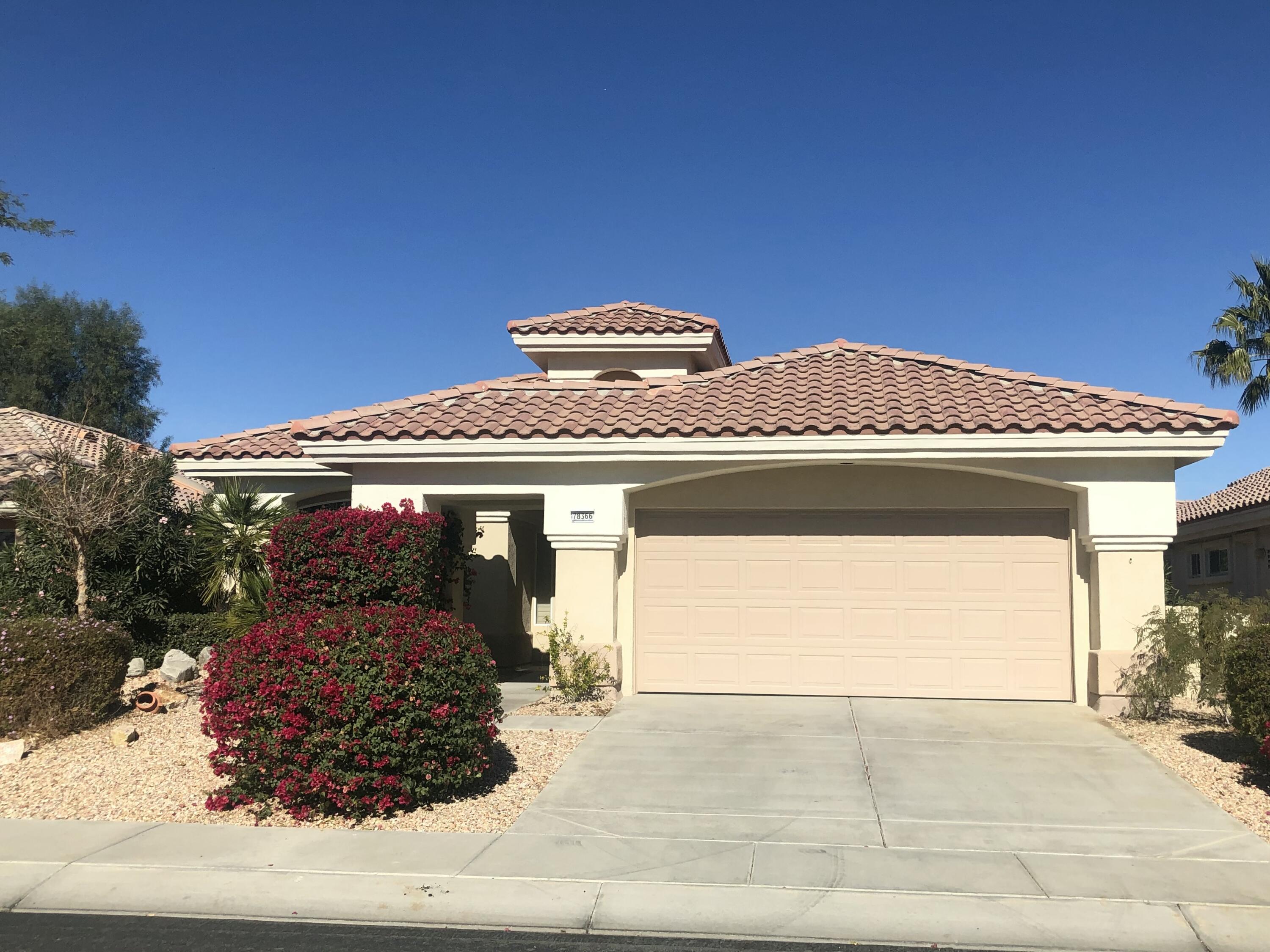 78366 Moongold Road Palm Desert, CA 92211 - Photo 2 of 17 a front view of a house with a garage