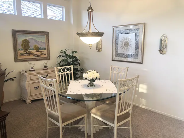 a view of a dining room with furniture wooden floor and a chandelier