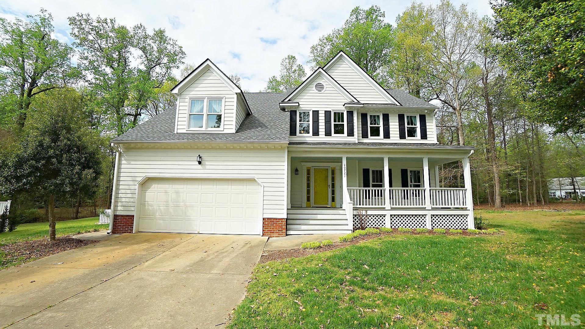 10721 Durant Road Raleigh, NC 27615 - Photo 1 of 37 a front view of a house with a yard and garage