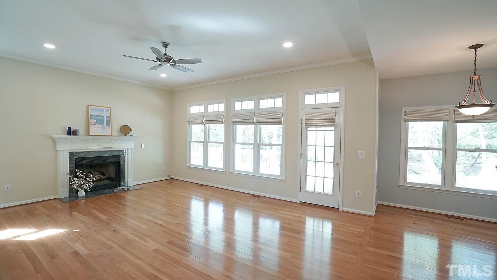 10721 Durant Road Raleigh, NC 27615 - Photo 15 of 37 a view of an empty room with window and wooden floor