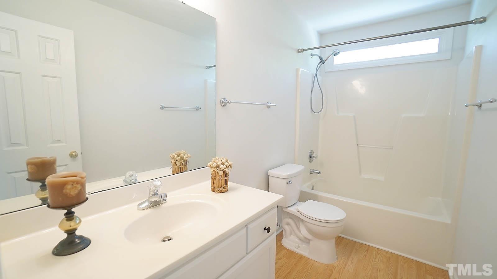 10721 Durant Road Raleigh, NC 27615 - Photo 25 of 37 a bathroom with a sink toilet and shower