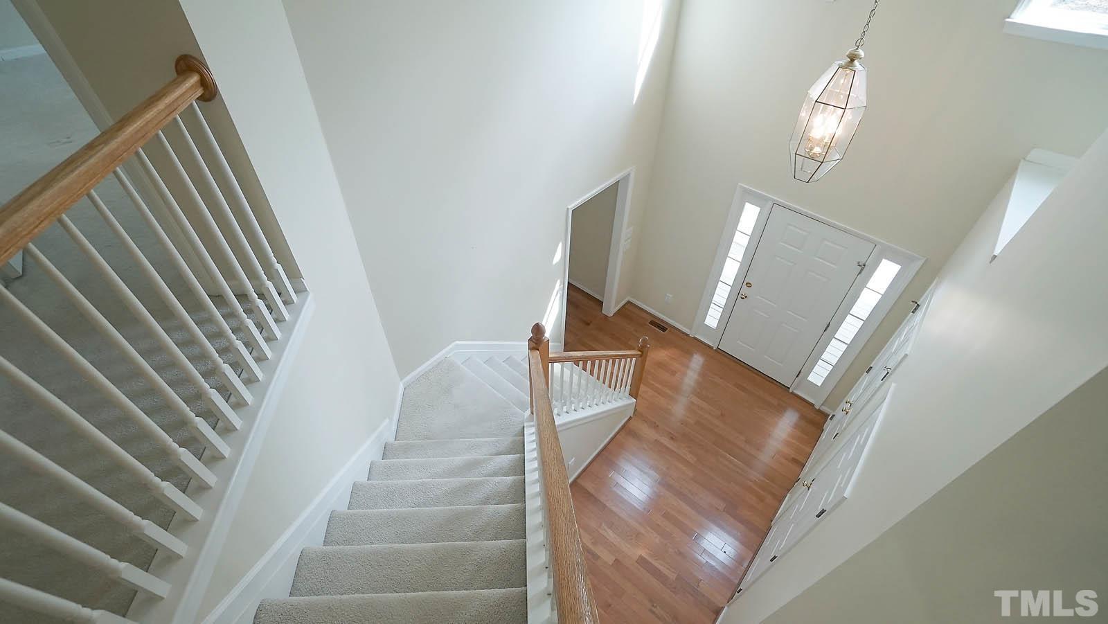 10721 Durant Road Raleigh, NC 27615 - Photo 5 of 37 a view of staircase with white walls and a window