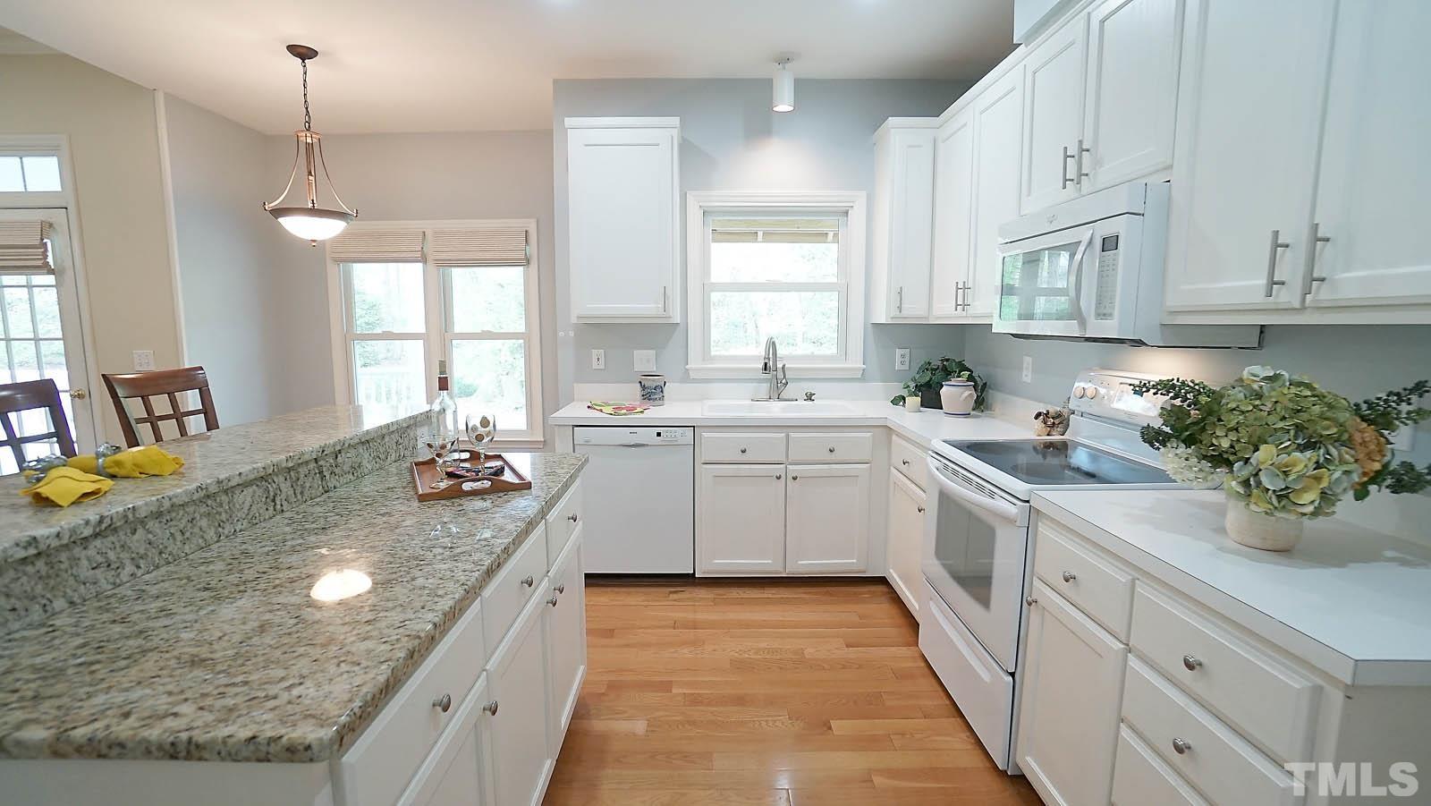 10721 Durant Road Raleigh, NC 27615 - Photo 9 of 37 a kitchen with sink stove and cabinets