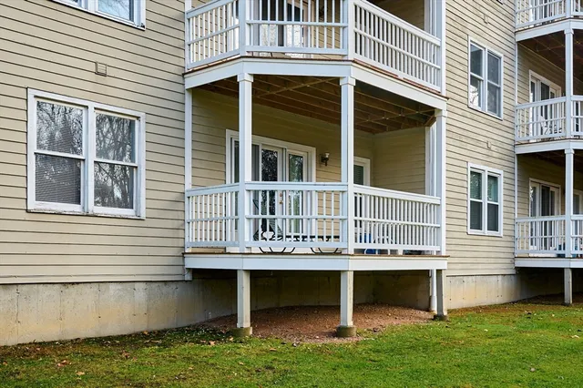 a view of a house with a yard and sitting area