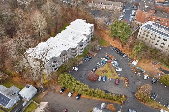 an aerial view of swimming pool patio and mountain view in back
