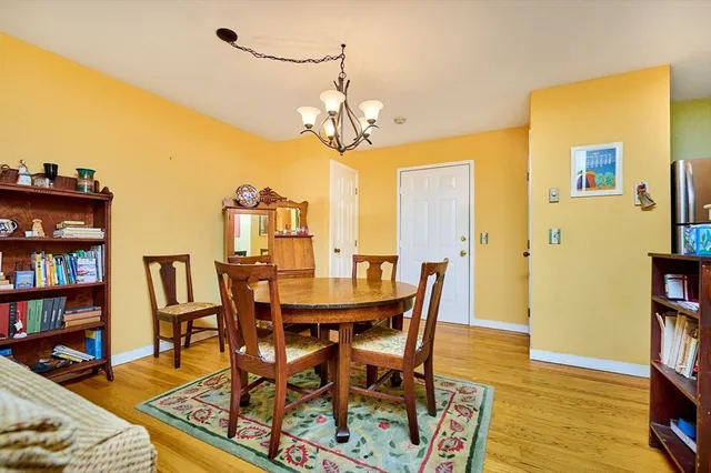a view of a dining room with furniture and a book shelf