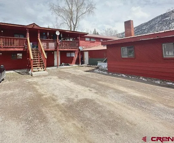 a view of a house with a yard and garage