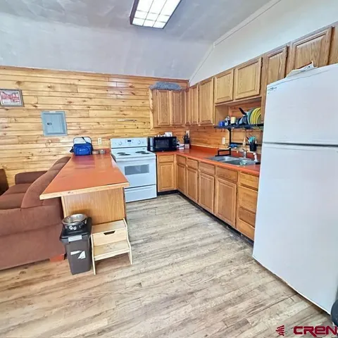 a view of a room with wooden floor and staircase