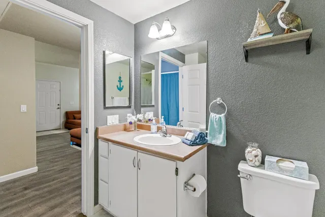 a bathroom with a toilet sink and mirror