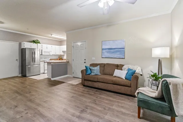 a living room with furniture and kitchen view