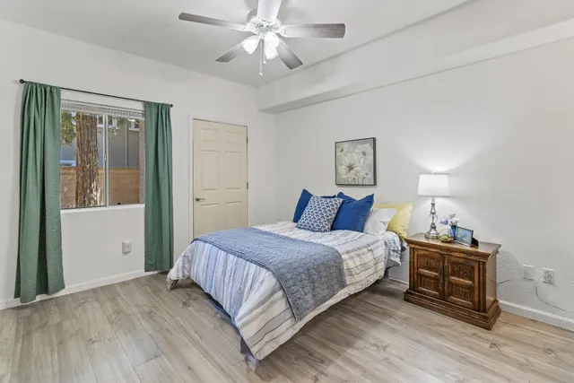 a bedroom with a bed and a chandelier