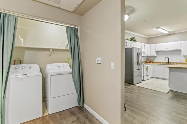 a view of kitchen with refrigerator and sink