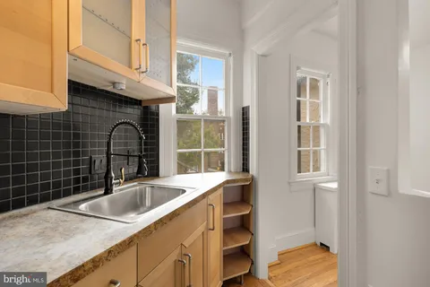 a kitchen with a sink and cabinets