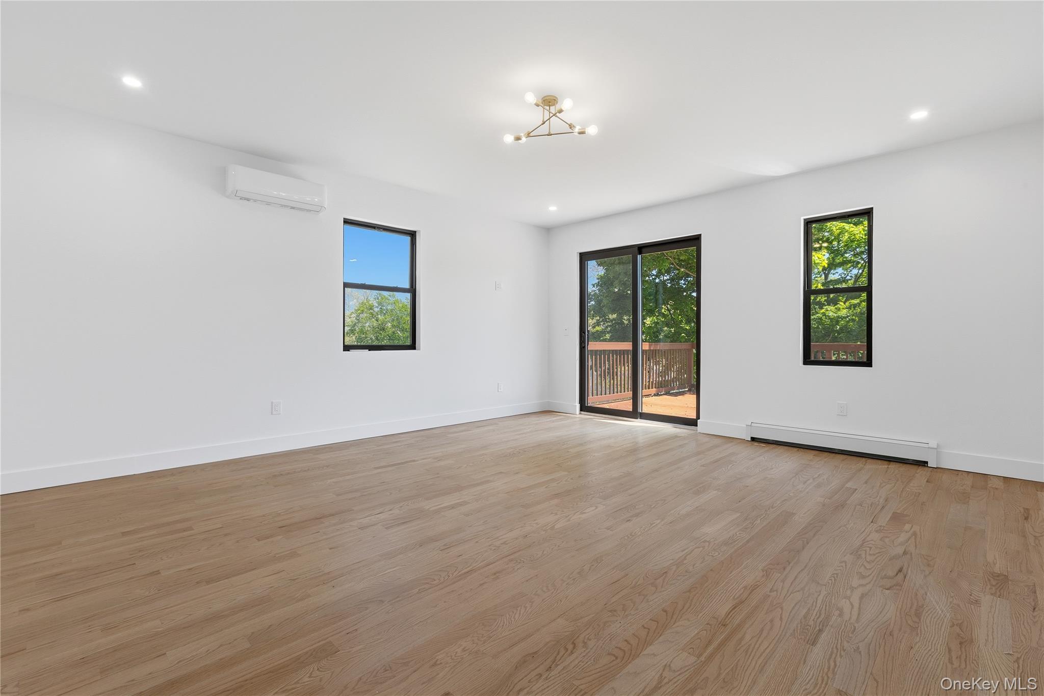 548 Lakes Road Monroe, NY 10950 - Photo 39 of 50 a view of an empty room with a window and wooden floor