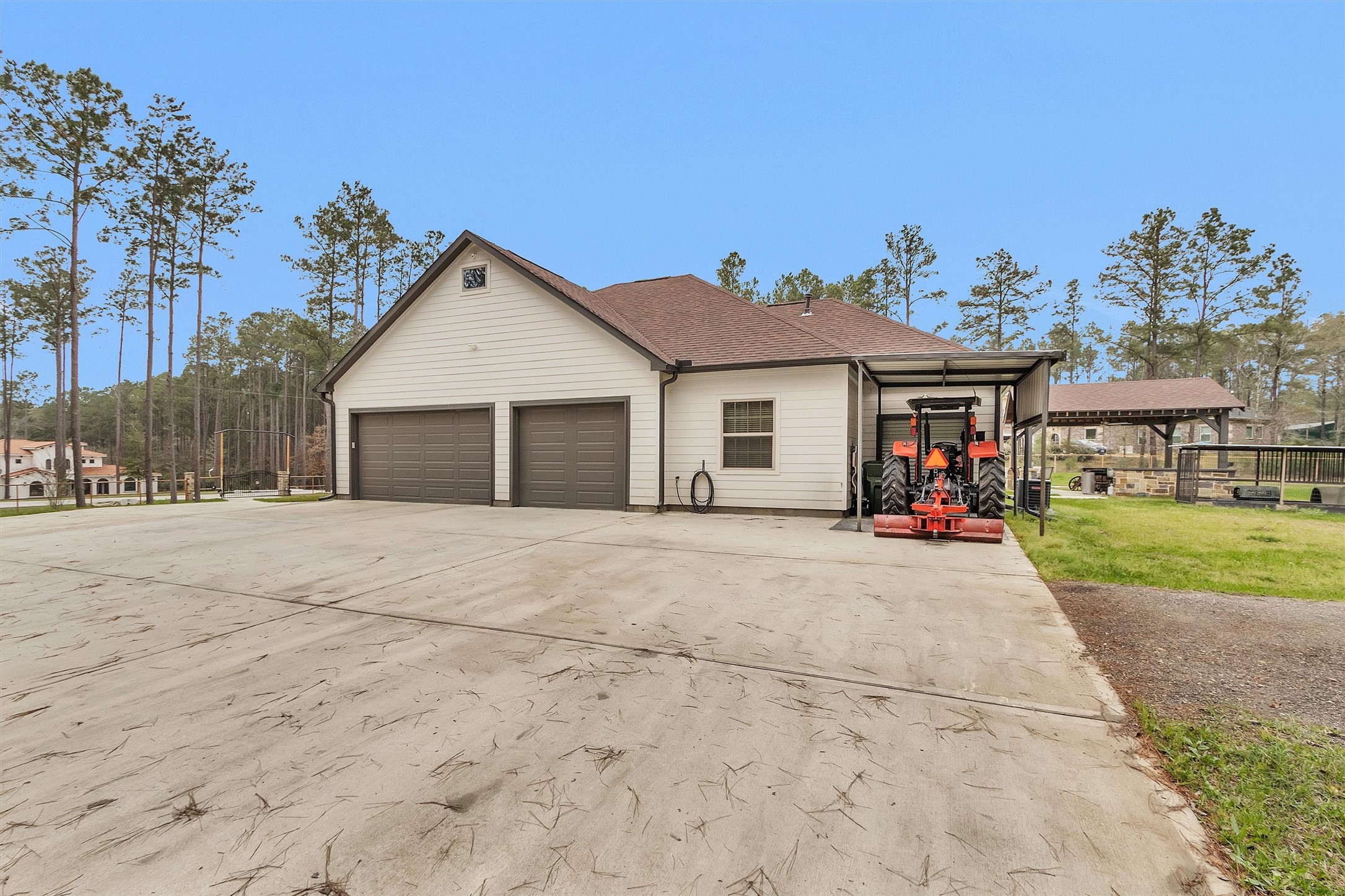 264 Grey Feather Road Huntsville, TX 77340 - Photo 27 of 31 Oversized 3+ car garage with epoxy floors plus additional space for equipment or tractor storage.