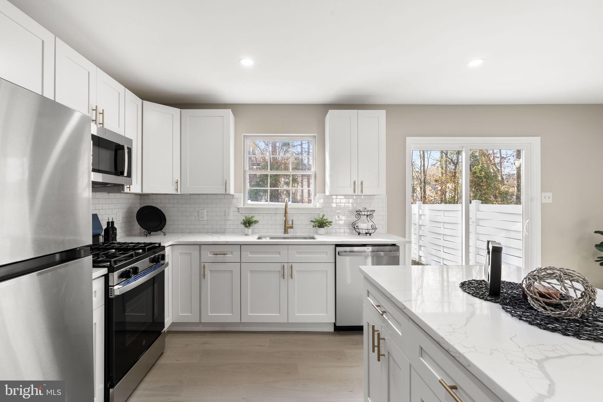 20 Elks Trail New Castle, DE 19720 - Photo 14 of 40 a kitchen with a sink stove top oven and cabinets