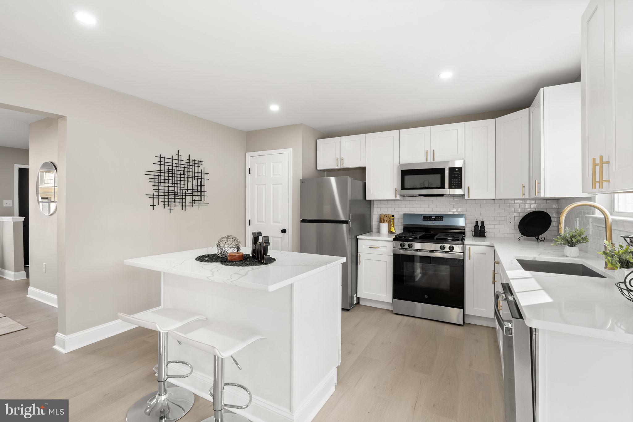 20 Elks Trail New Castle, DE 19720 - Photo 15 of 40 a kitchen with kitchen island a sink stainless steel appliances and cabinets