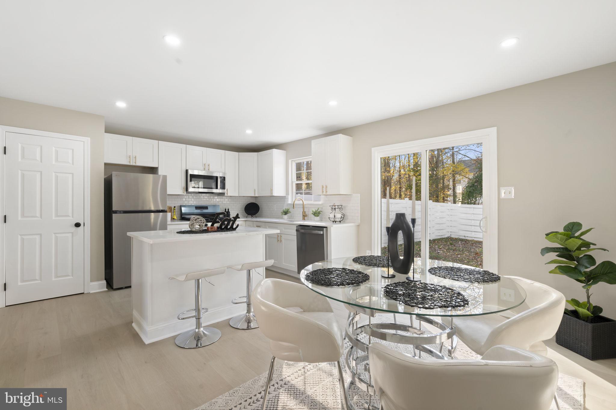 20 Elks Trail New Castle, DE 19720 - Photo 19 of 40 a kitchen with granite countertop white cabinets and stainless steel appliances