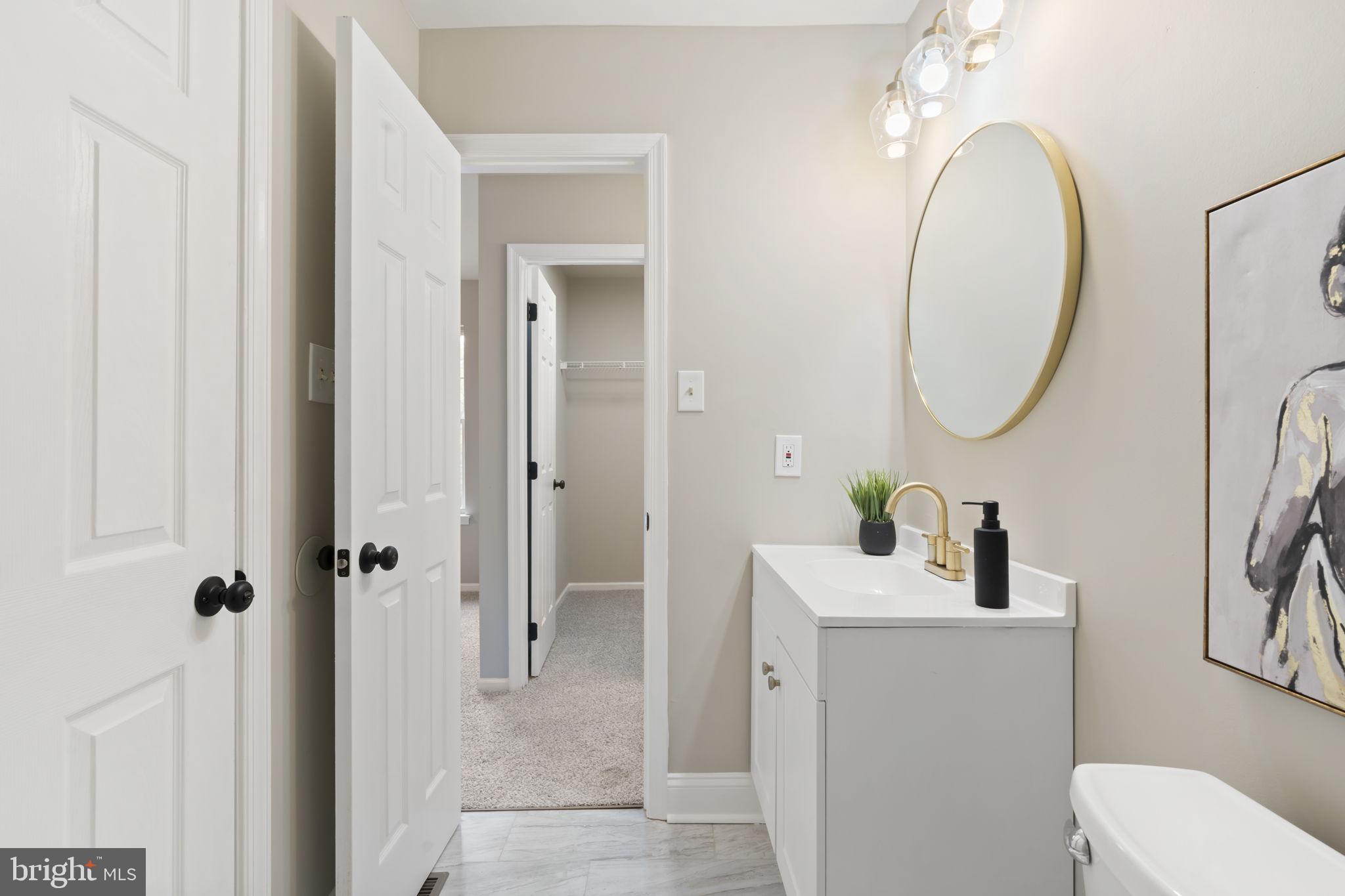 20 Elks Trail New Castle, DE 19720 - Photo 29 of 40 a bathroom with a toilet sink vanity and mirror