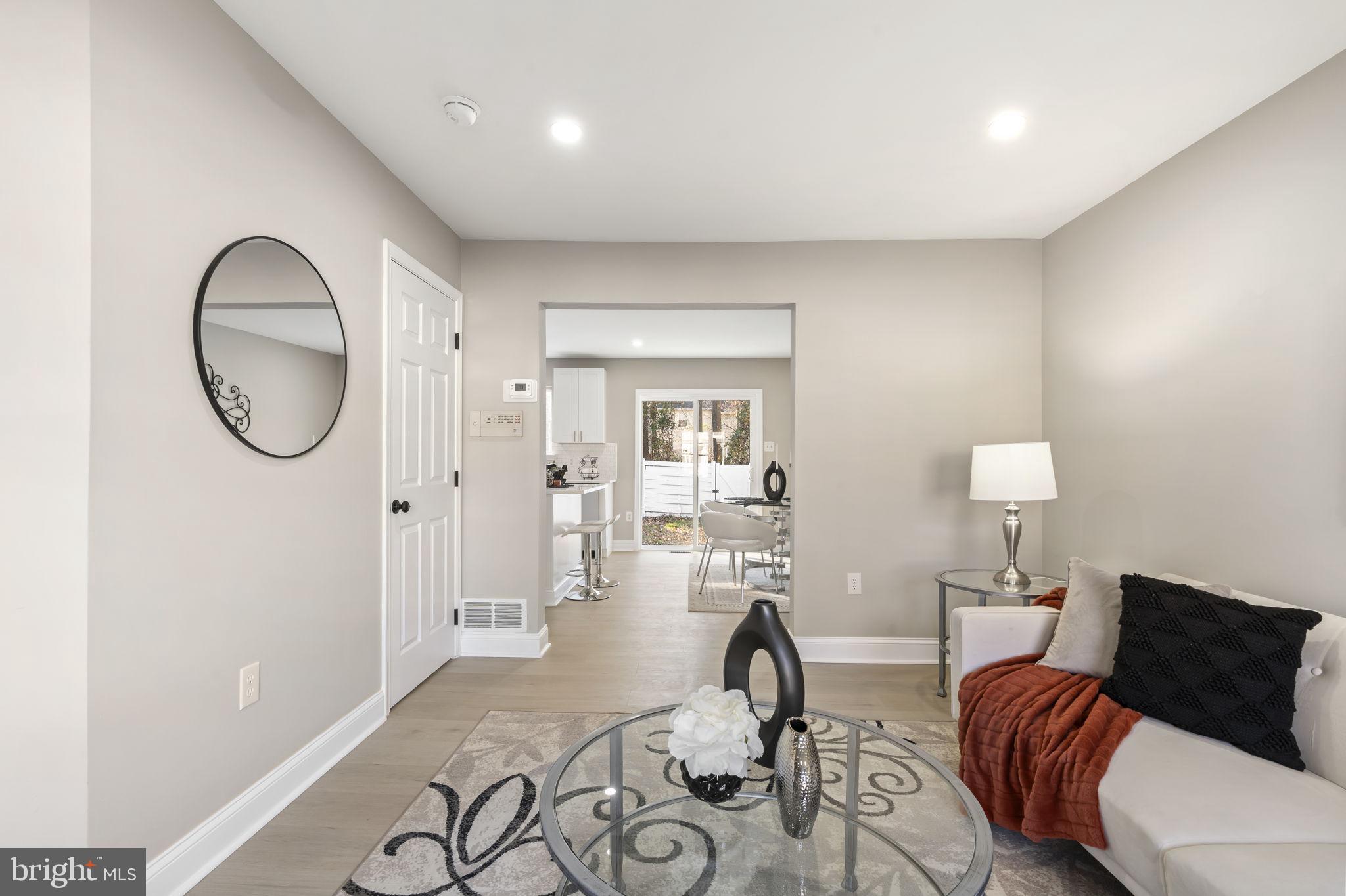 20 Elks Trail New Castle, DE 19720 - Photo 7 of 40 a living room with furniture a mirror and a wooden floor