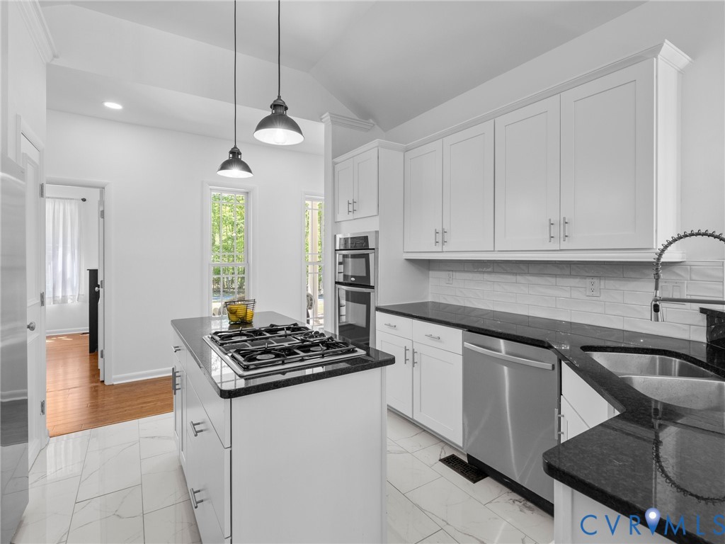 6126 Autumn Bluff Road Powhatan, VA 23139 - Photo 22 of 47 a kitchen with stainless steel appliances a sink a stove a refrigerator and cabinets