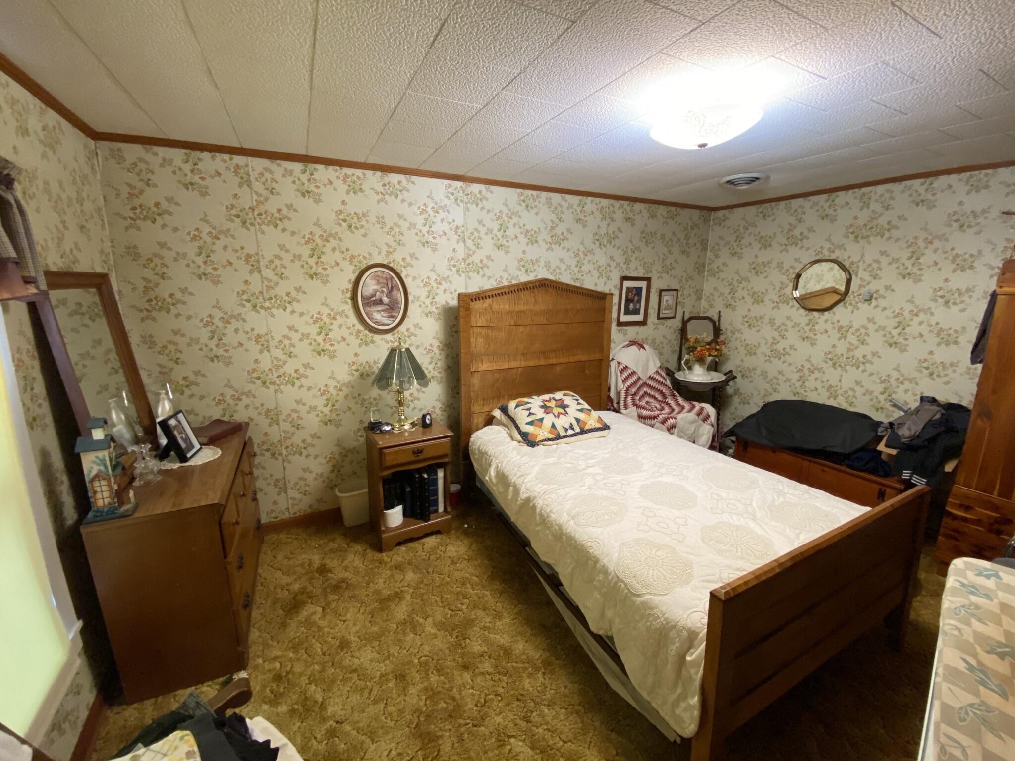 759 Runnett Bag Road Ferrum, VA 24088 - Photo 14 of 74 a bed room with a bed and a chair