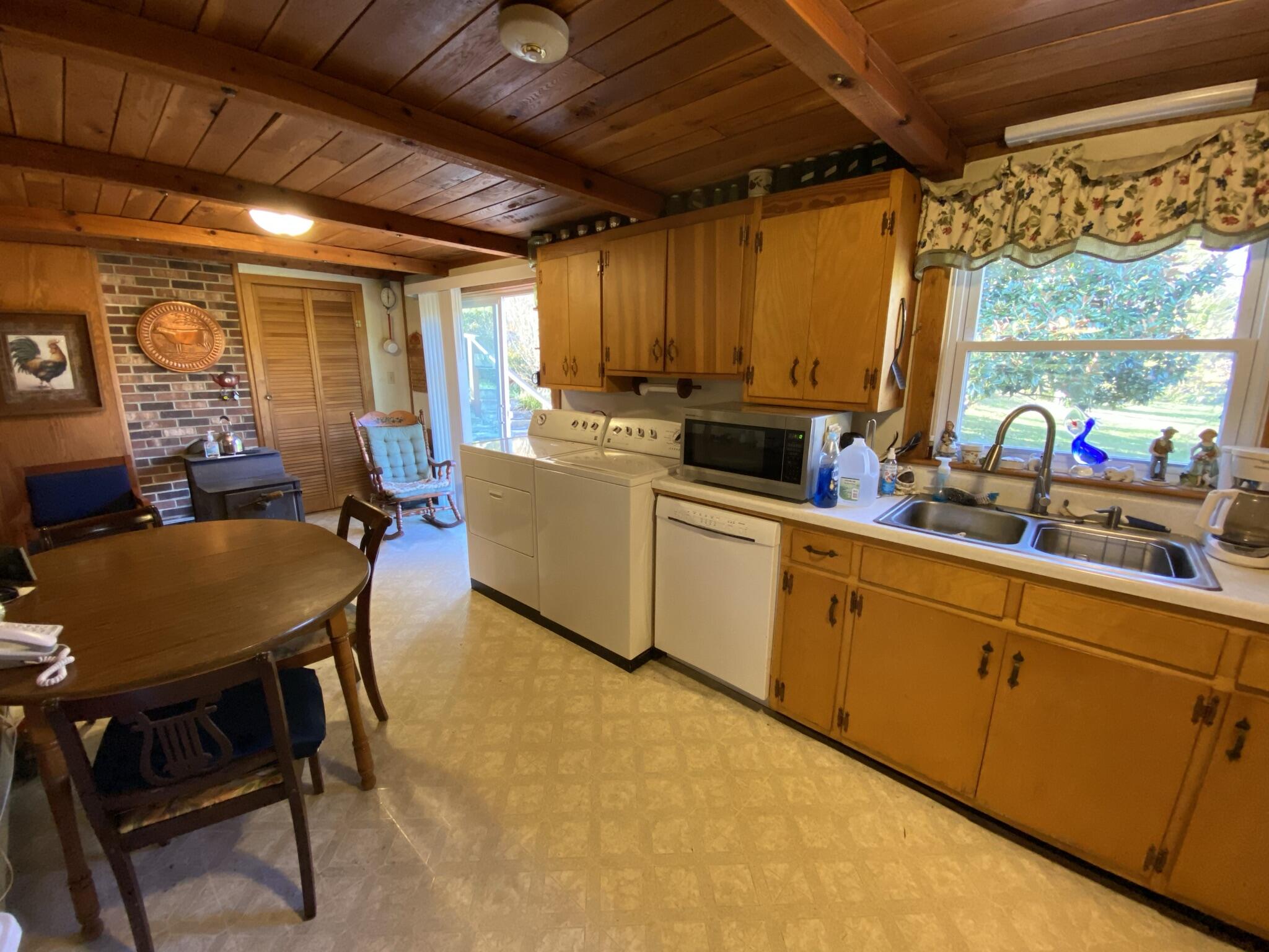 759 Runnett Bag Road Ferrum, VA 24088 - Photo 40 of 74 a kitchen with a sink and wooden cabinets