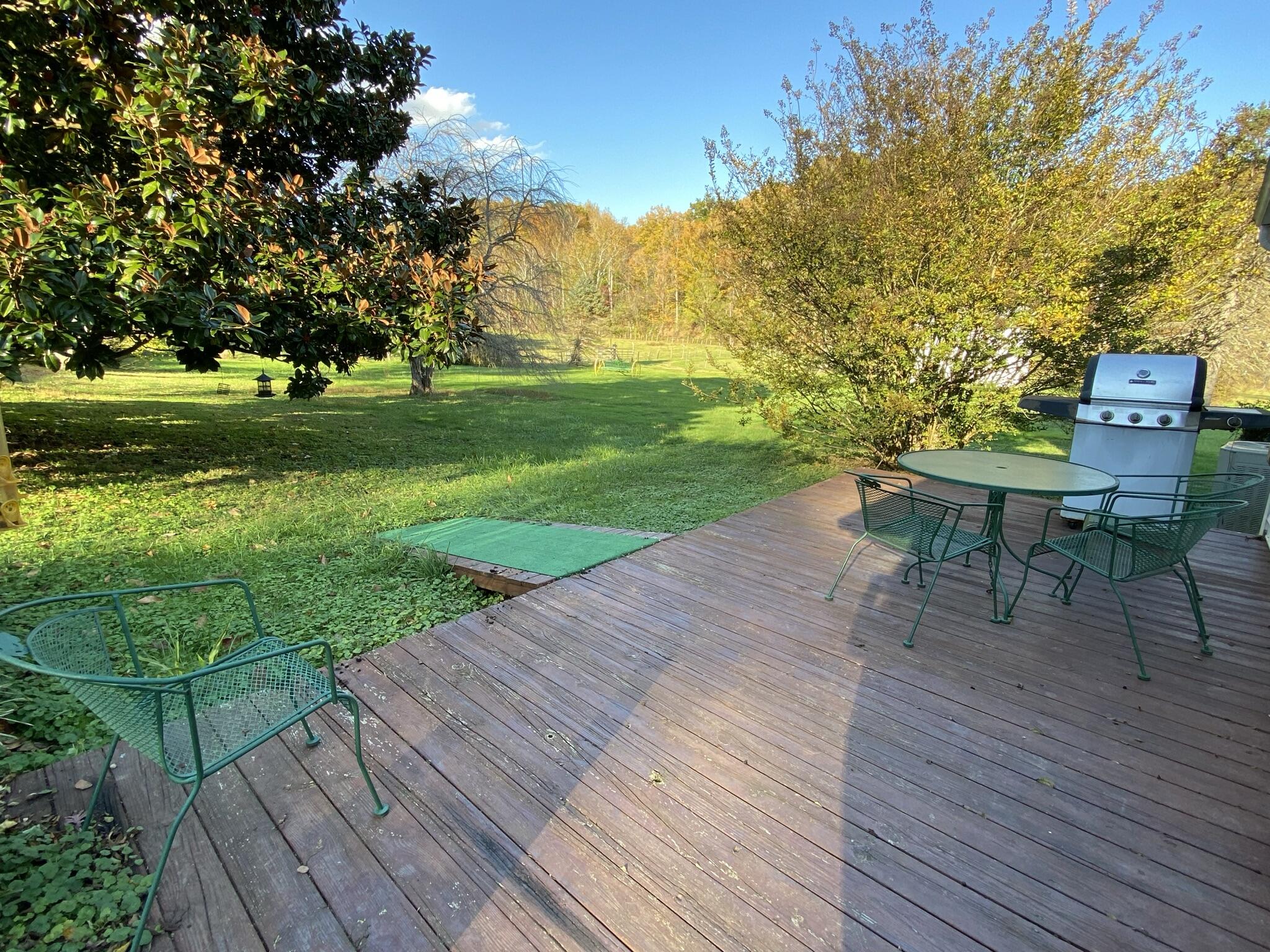 759 Runnett Bag Road Ferrum, VA 24088 - Photo 55 of 74 a view of a patio with table and chairs with wooden floor and fence