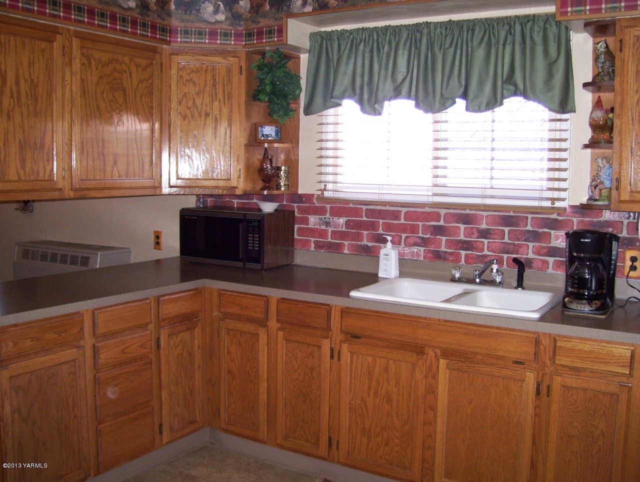 1401 Franklin Road Tieton, WA 98947 - Photo 11 of 20 a kitchen with granite countertop a sink a stove and cabinets