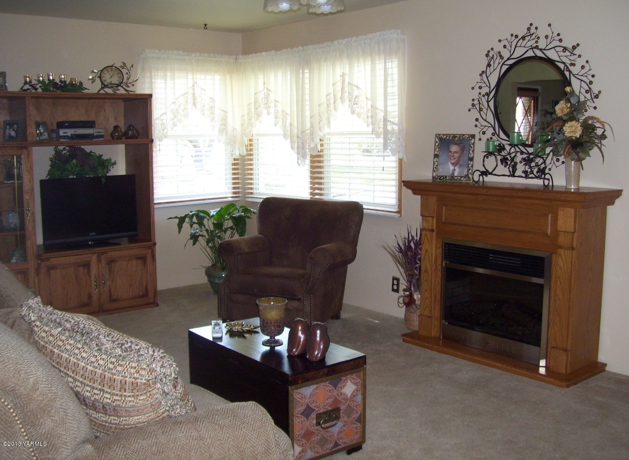 1401 Franklin Road Tieton, WA 98947 - Photo 8 of 20 a living room with furniture a fireplace and a flat screen tv