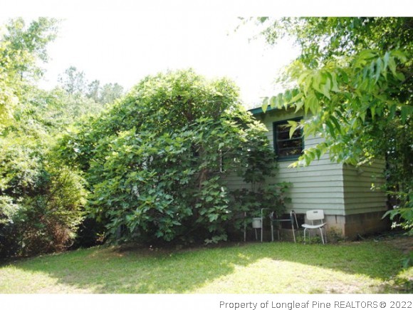 1306 Colon Road Sanford, NC 27330 - Photo 7 of 8 a view of backyard with plants and outdoor seating