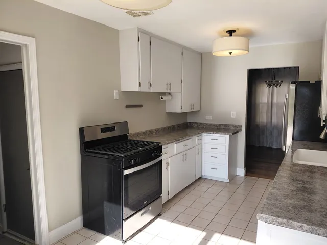 a kitchen with granite countertop cabinets and steel stainless steel appliances